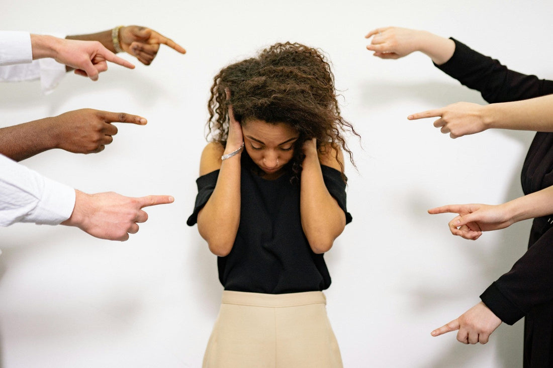 Anxious woman being pointed at