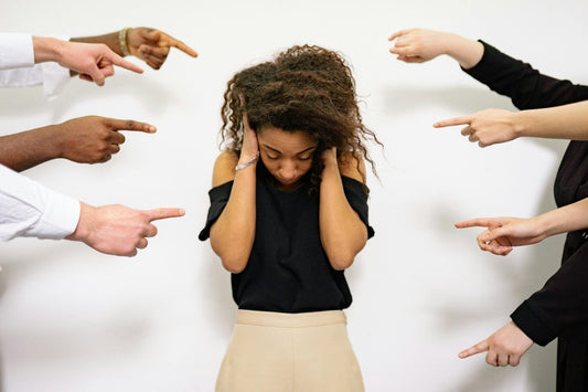 Anxious woman being pointed at