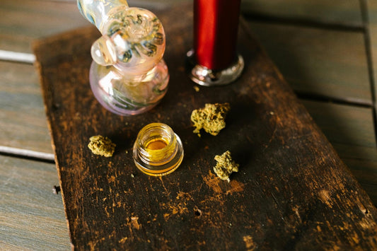 Cannabis items arranged on a wooden plate