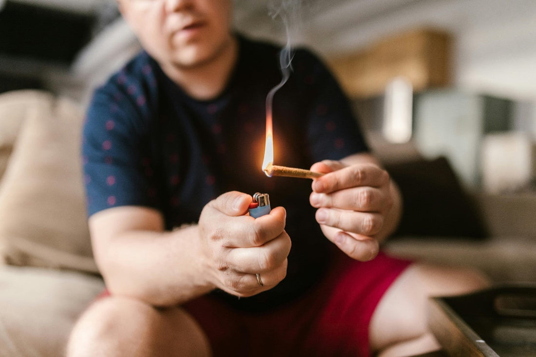 Man lighting a joint with a lighter