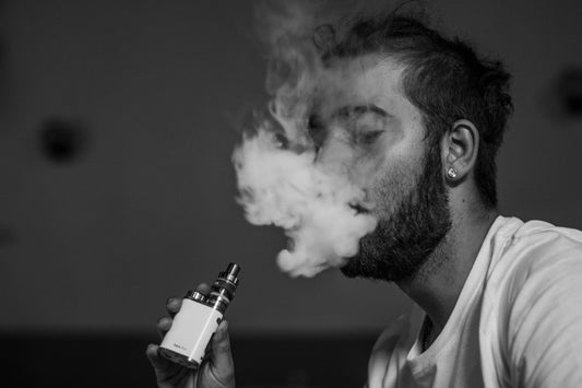 A man using a vape device