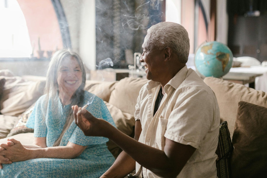 Man and a woman smoking weed and laughing