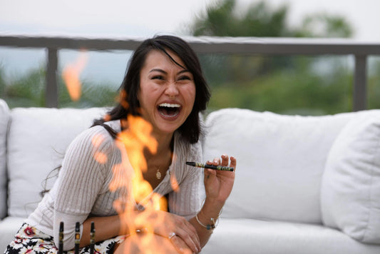 Woman smoking cannabis with fire in the foreground