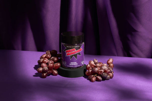 Delta Munchies 1000mg Delta 8 THC gummies grape gushers on a purple back drop