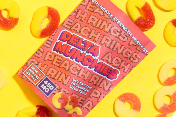 Bag of Delta Munchies' Peach Rings Delta 8 Gummies on a yellow background.