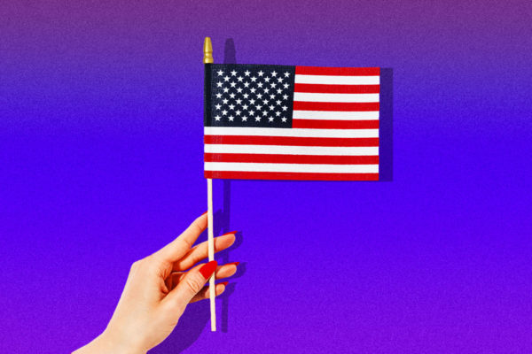 Woman's hand holding an American flag.
