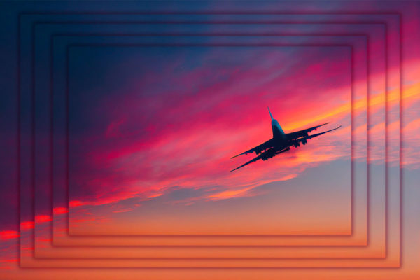 Photo of a plane taking off into a pink sunset.