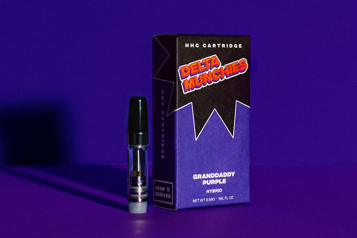 Delta Munchies' Grandaddy Purp HHC vape cartridge on a purple background.