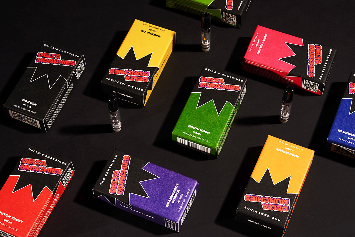 Assorted boxes of Delta Munchies' cartridges on a black surface.