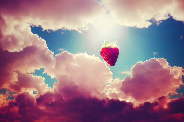 Strawberry floating on a light blue and pink sky.