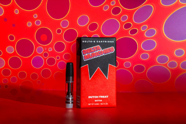 Delta Munchies' Dutch Treat delta 8 vape cartridge on a red background with purple spots.