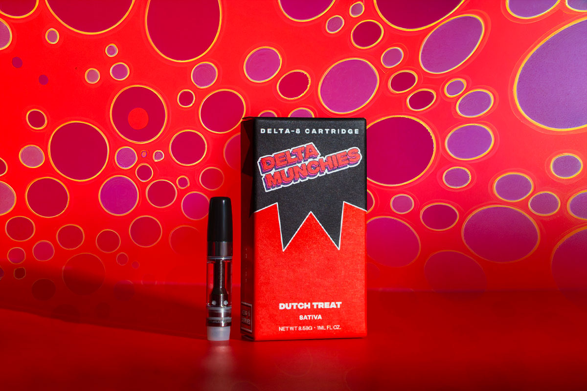 Delta Munchies' Dutch Treat delta 8 vape cartridge on a red background with purple spots.