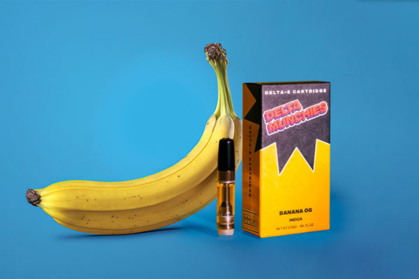 Delta Munchies' Banana OG delta 8 cartridge next to a banana.