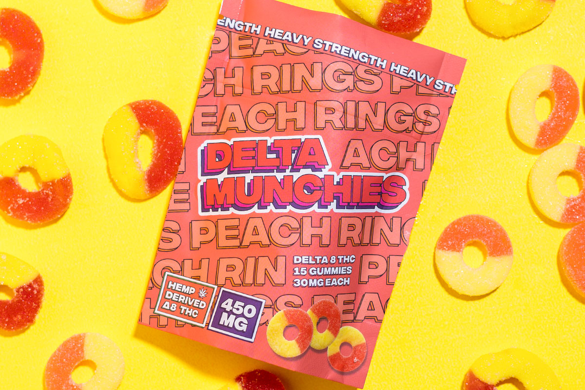 Delta Munchies' Peach Rings delta 8 gummies on a yellow background.