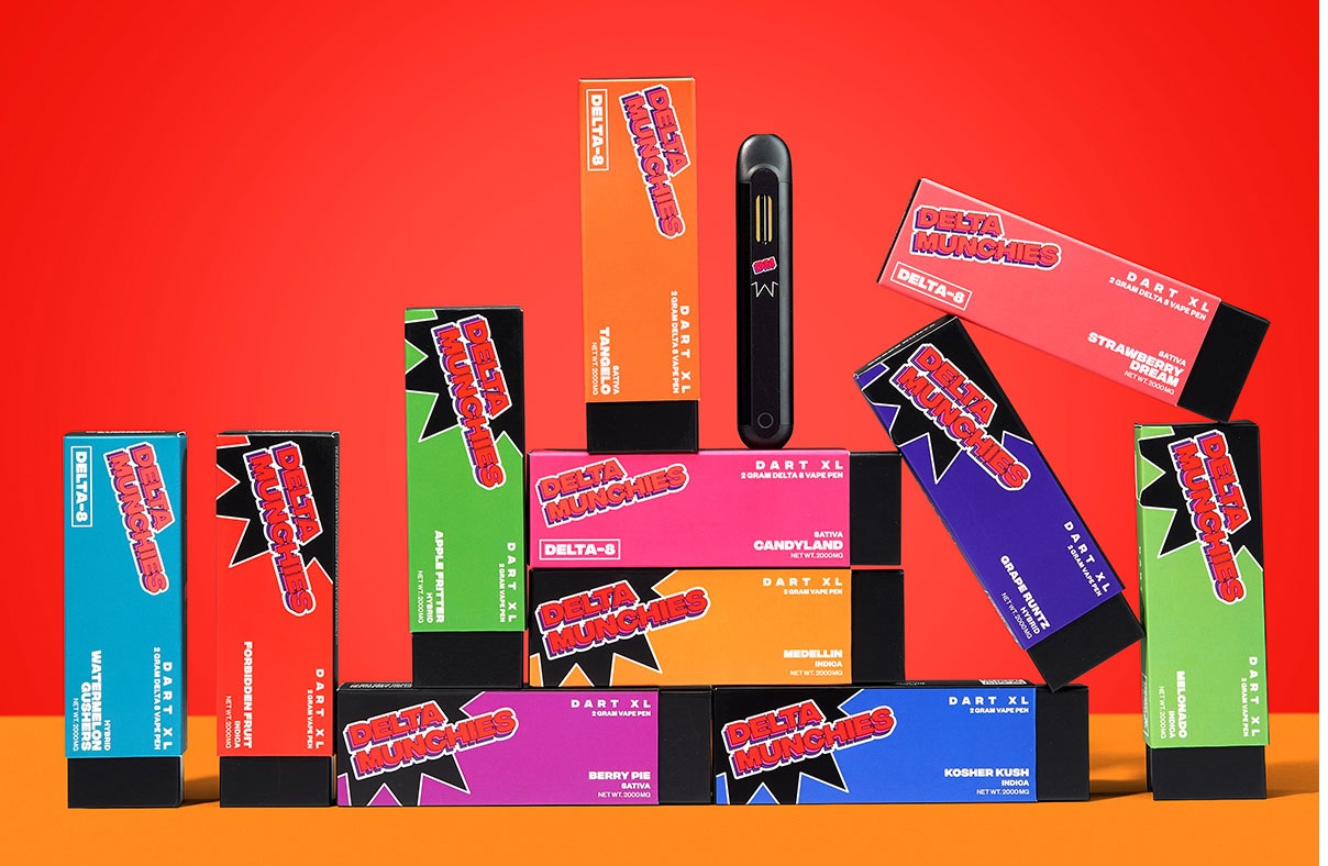 Ten packs of Delta Munchies Vape Pens of different flavors with a red and orange color backdrop