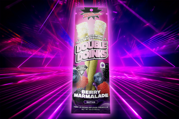 A pack of Delta Munchies Double Doinks with Berry Marmalade flavor kept against a pink light background
