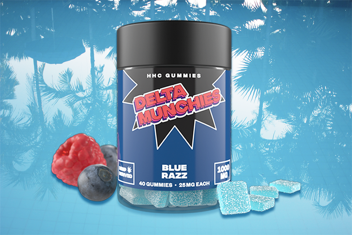 Delta Munchies HHC Gummies in Blue Razz flavor, surrounded by strawberry, blackberry & blue gummies, set against a glossy blue background with tree reflections