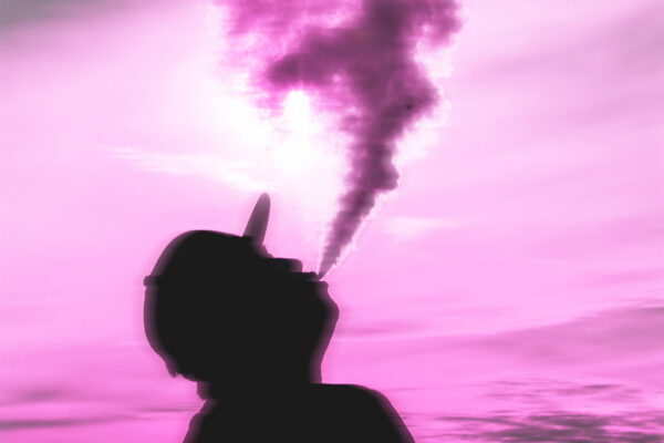 A man in a hat, face up, exhaling smoke against a purple sky