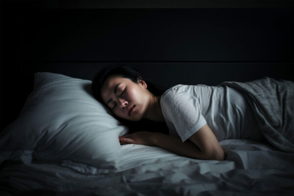 Woman laying in bed sleeping.